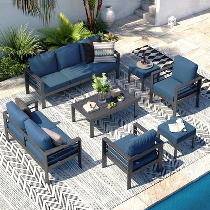 Seven piece aluminum patio furniture set with a coffee table