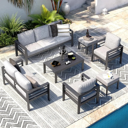 Seven piece aluminum patio furniture set with a coffee table